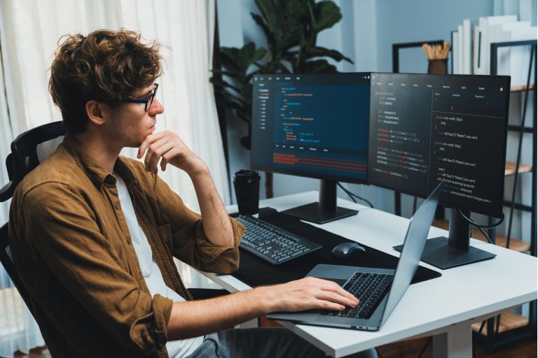 Working IT developer with stressful overworked in creating online software development coding on pc screen, thinking program for latest version application on website project at modern office. Gusher.