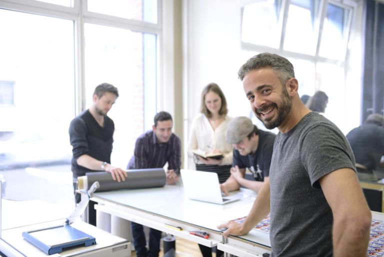 Publisher advertising agency owner working with team on a creative project.