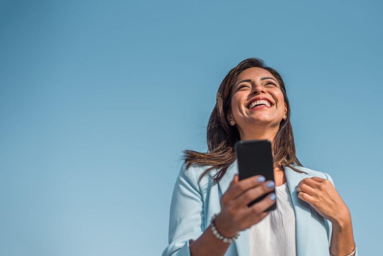 Portrait of a young girl happy with her cell phone. Copy space