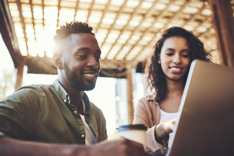 Laptop, search and couple at a cafe for online, menu or brunch food choice, scroll or customer service survey. Pc, love and happy people a at coffee shop for hotel booking or accommodation decision.
