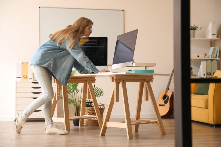 Female programmer working with computer at table in office