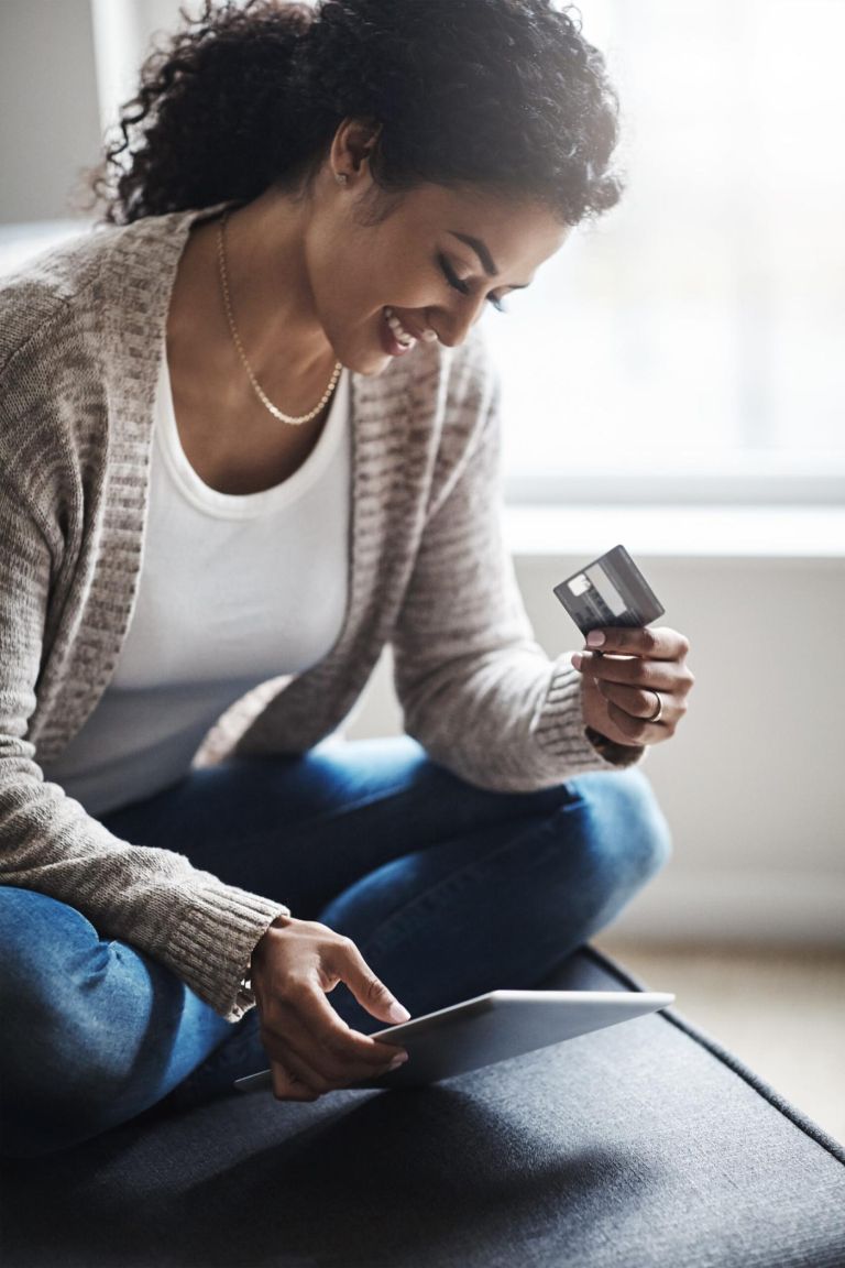 Woman, tablet and happy in house with credit card, online banking and security details for mobile app in home. Ecommerce, fintech payment and shopping on website, customer and digital transaction.