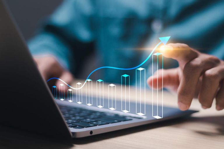 Analysis concept. Businessman use laptop with virtual screen of economic growth graph for business strategy, data analysis technology and financial growth concept.